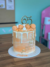 Load image into Gallery viewer, Macaron and Meringue Loaded Cake with Gold Leaf detail
